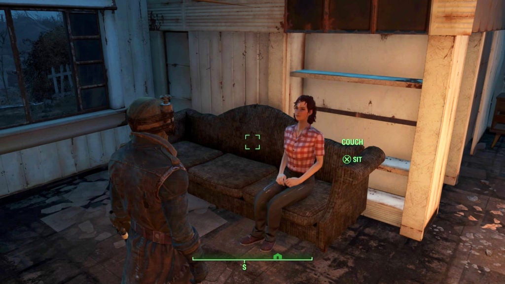 The player about to sit on a couch in their home next to Cait, one of their companions, who is wearing a red and white shirt as well as blue pants.