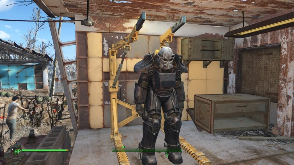 A dark grey and white suit of power armor standing in a yellow armor station.