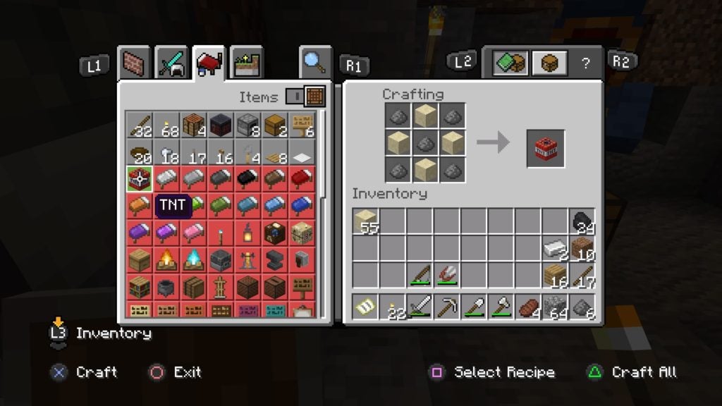The player making TNT on a crafting table by using 4 sand and 5 gunpowder.