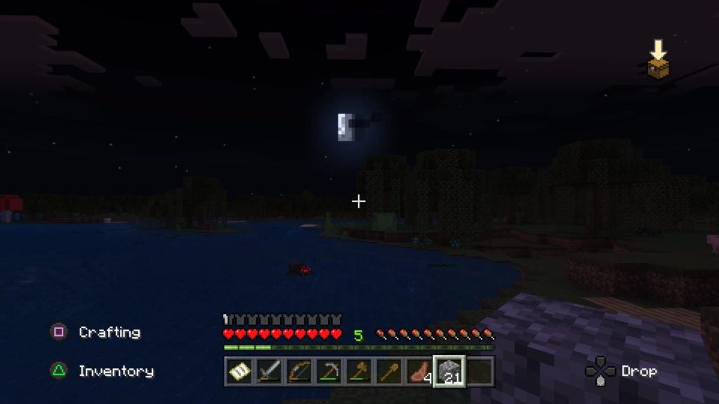 The player looking at the moon over a swamp biome while a spider swims in the water.
