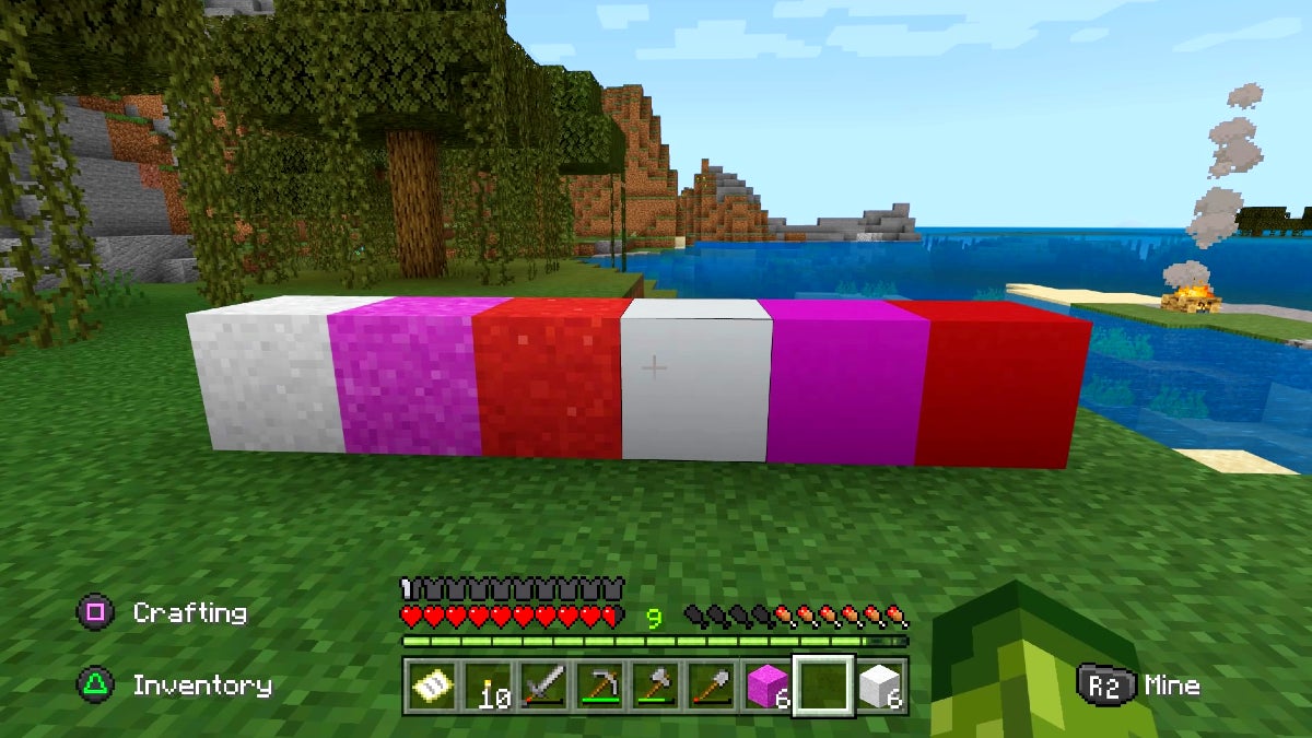 The player is looking at a row of brightly colored blocks. There are 3 concrete powder blocks on the left and 3 finished concrete blocks on the right. There is a white, magenta, and red version of each kind of block.