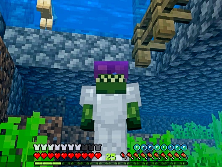 The player is looking at themselves in third-person view while they are underwater. They are wearing iron armor and an enchanted leather helmet.