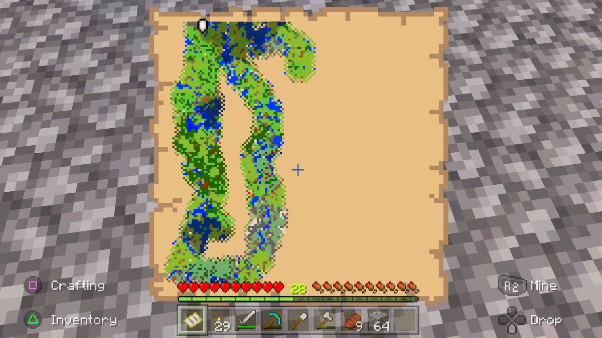 The player holding and looking down at a partially uncovered map. The left side is somewhat explored and shows lots of green fields and forests.