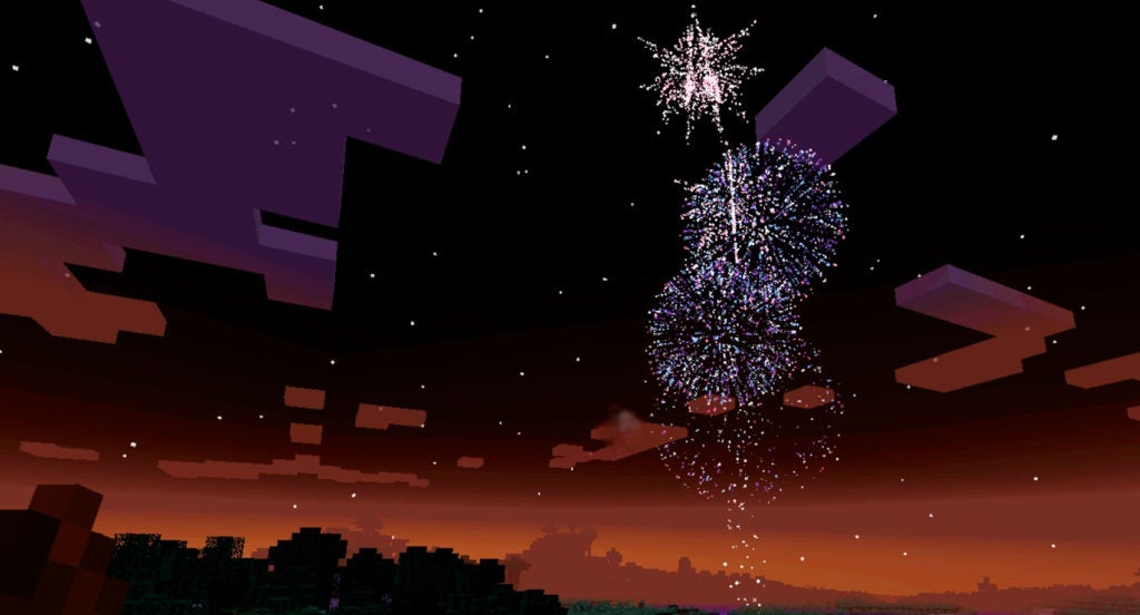 Fireworks going off in the orange dusk sky. the explosions are of white sparks in the shape of spheres and a star.