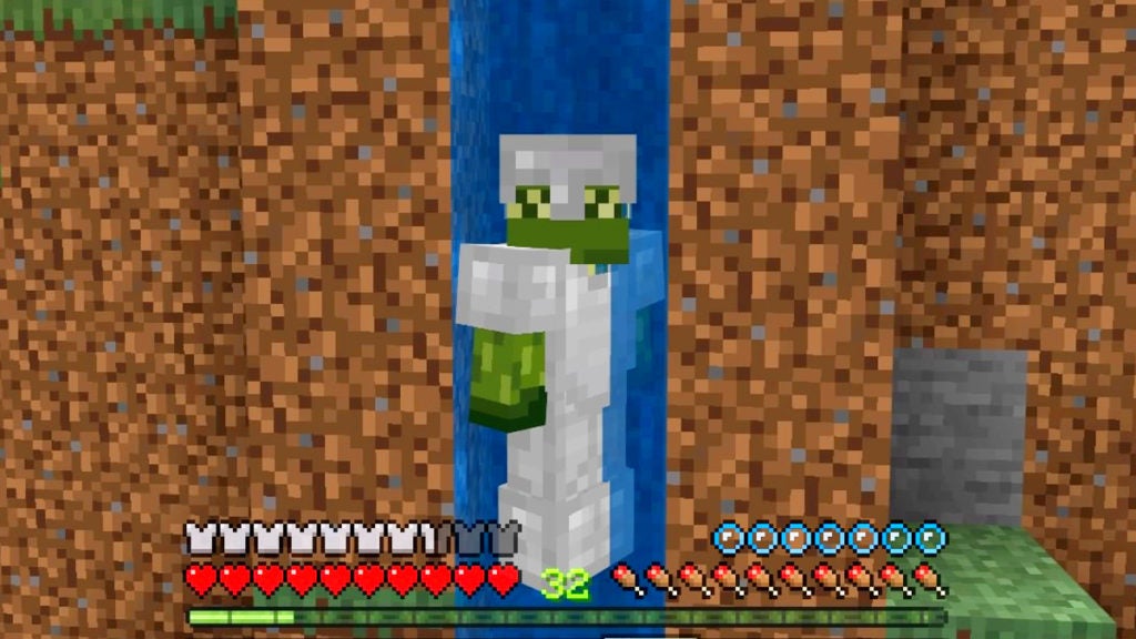 The player in third person view swimming up a thin waterfall while wearing iron armor.