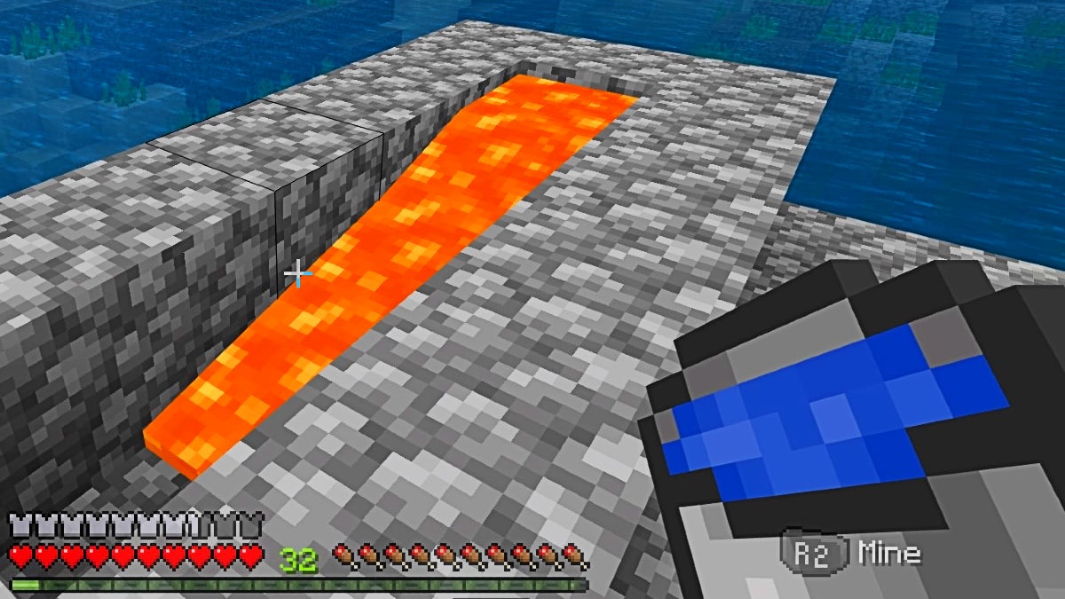 The player about to dump a bucket of water out near some lava.