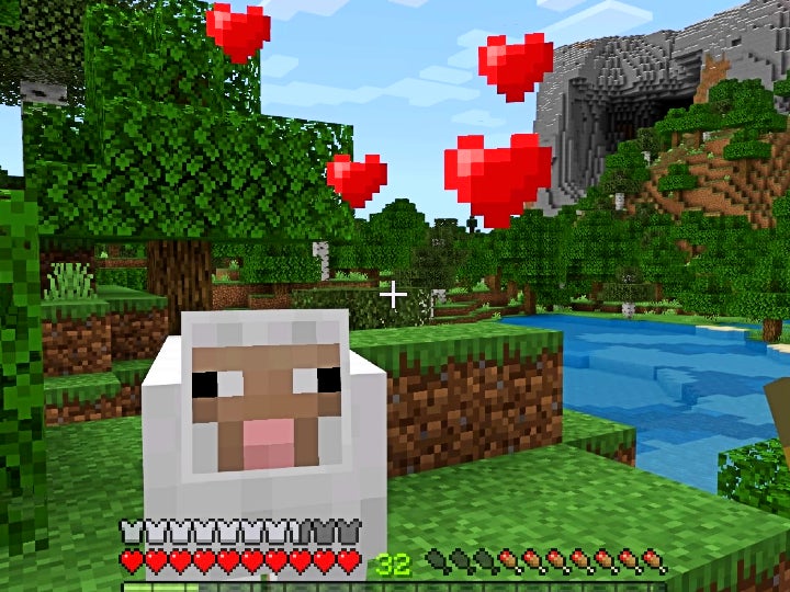 An adult white sheep looking at the player with red hearts above their head.