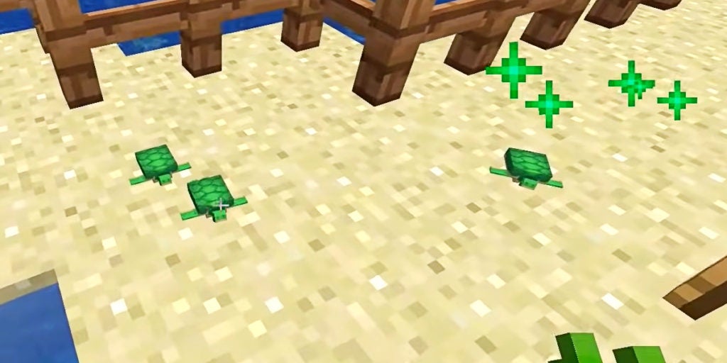 There are 3 baby turtles on some sand with green particle effects above them. The particle effects indicate they've been fed.