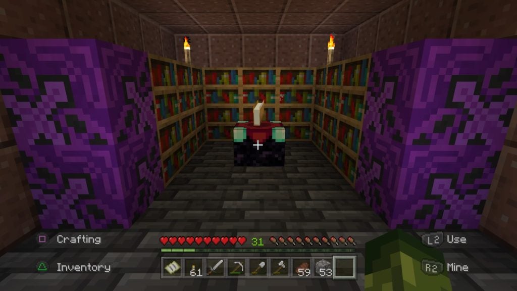 A red and black enchanting table with a floating book surrounded by bookshelves. The player is a few blocks away from the enchanting table.