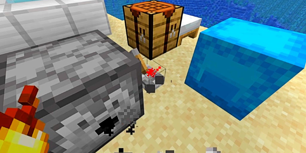 The player using a lever to activate a dispenser in front of them while on a sandy island. There is a blue block and a crafting table nearby.