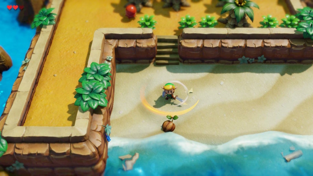 Link performing a spin attack with his sword on the beach.
