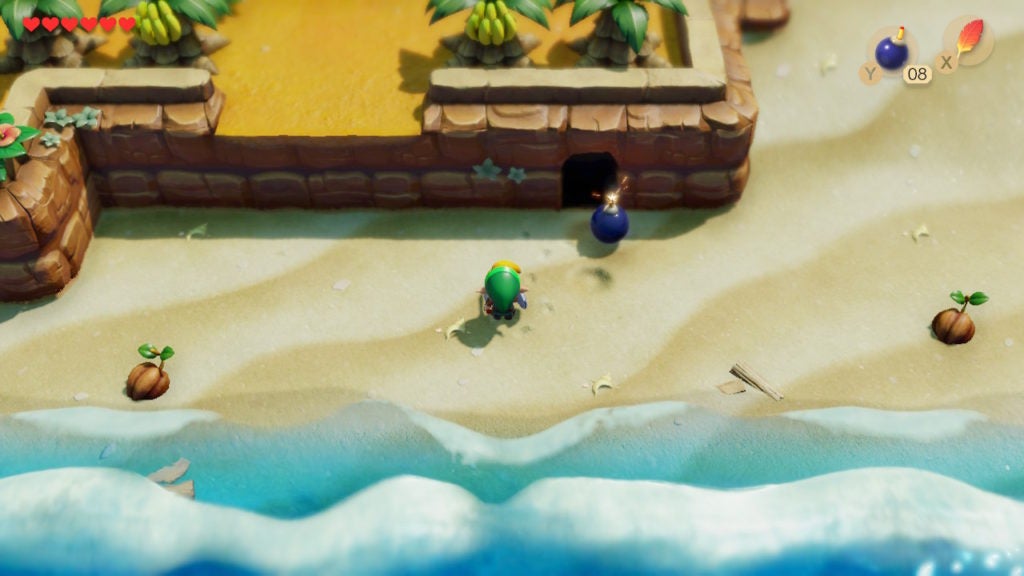 Link blowing open an entrance to a cave on Toronbo Shores with a Bomb.