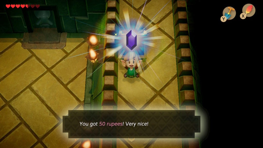 Link holding a purple Rupee above their head happily.