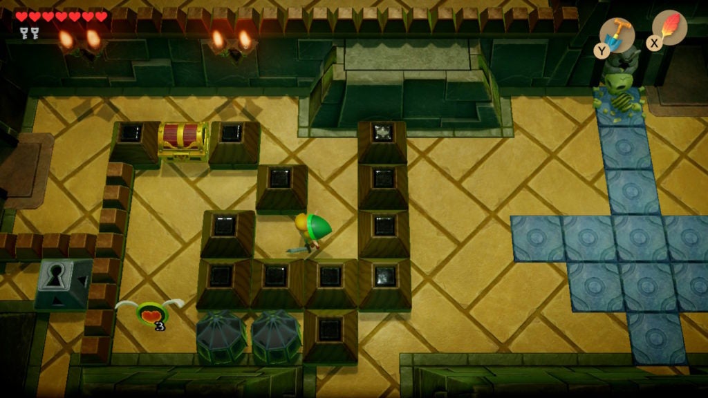 Link looking at a chest beyond some blocks.