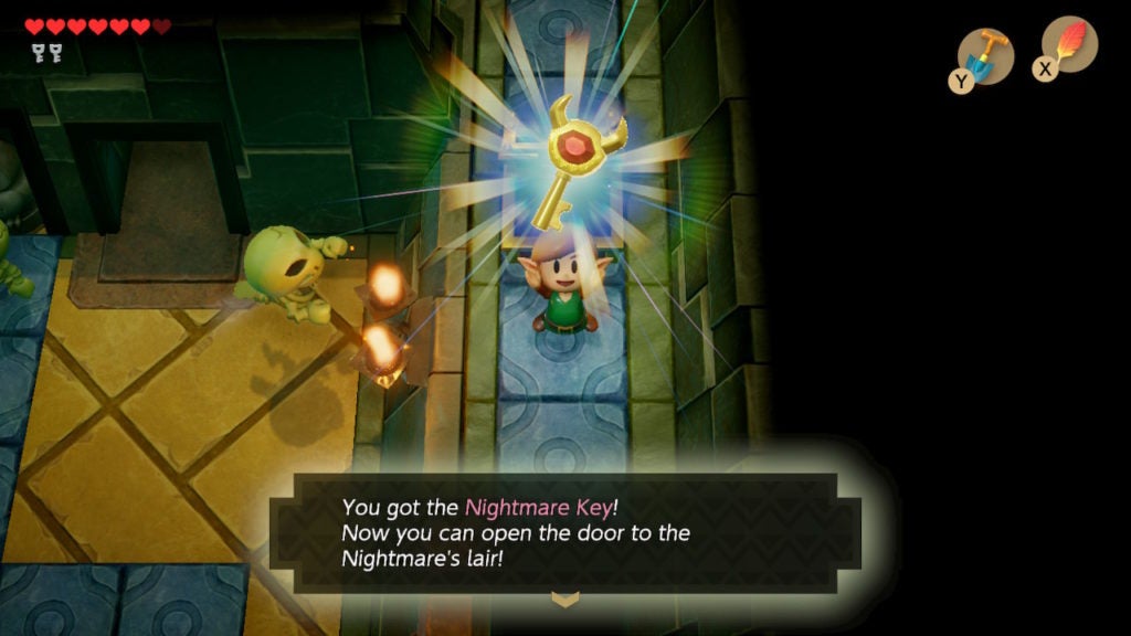 Link holding up an ornate key.