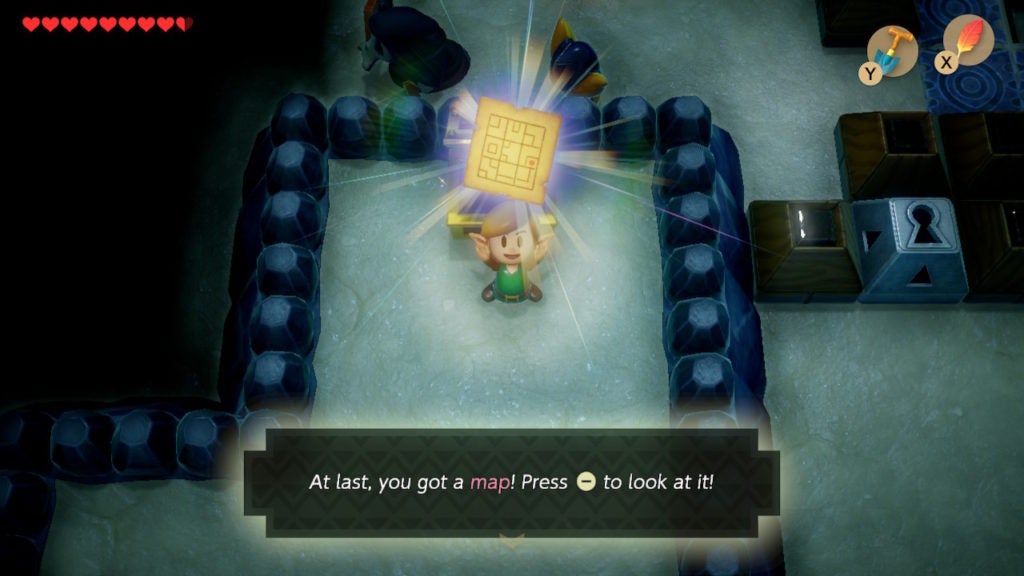 Link holding up the dungeon map.