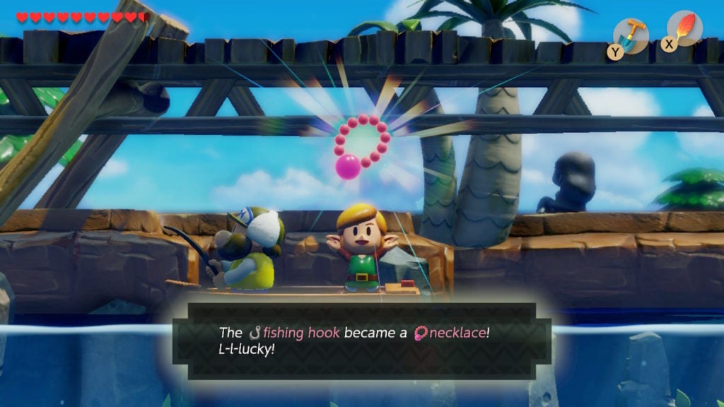 Link holding up a Necklace and seems to be made from pink pearls.