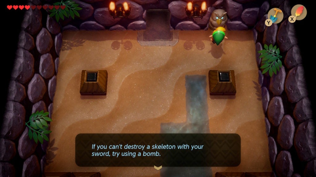 Link talking to an Owl Statue, which tells him to use bombs against skeletal enemies.