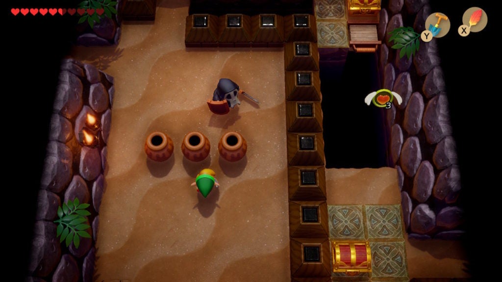 Link walking north in a large room with a Sword Stalfos and a chest visible in the southeast beyond a barricade.
