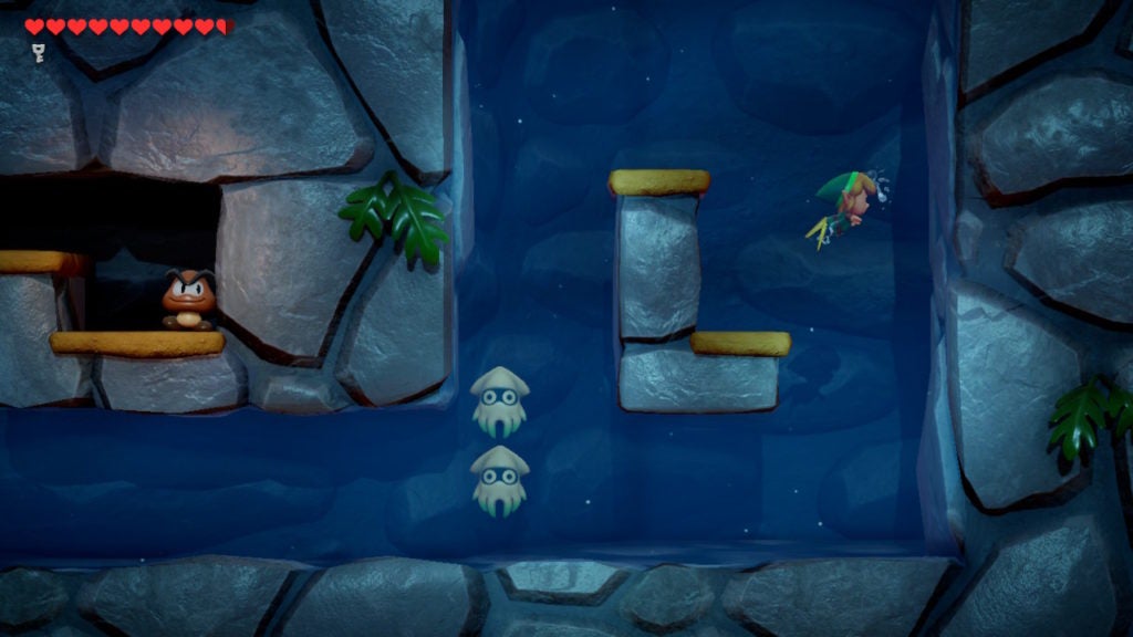 Link swimming next to 2 Bloopers in a side-view underwater cavern.