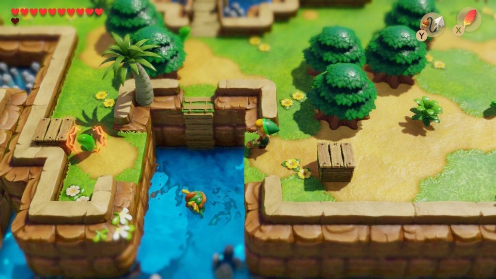 Link looking at a gap over some water with a wooden box on either side.