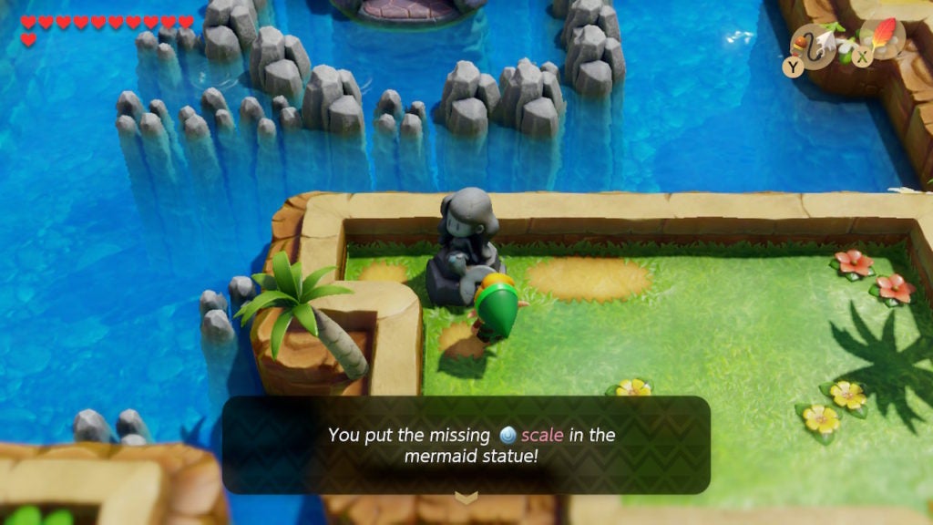 Link inserting a Scale into the Mermaid Statue to complete it.