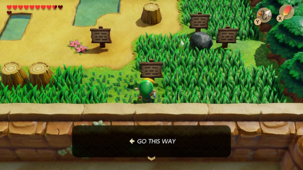 Link reading a signpost telling him to go west through some tall grass.