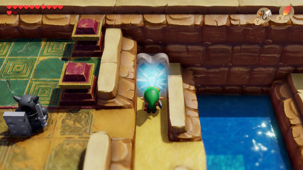 Link using the Face Key to unlock the next dungeon. The keyhole he inserts it into glows white.