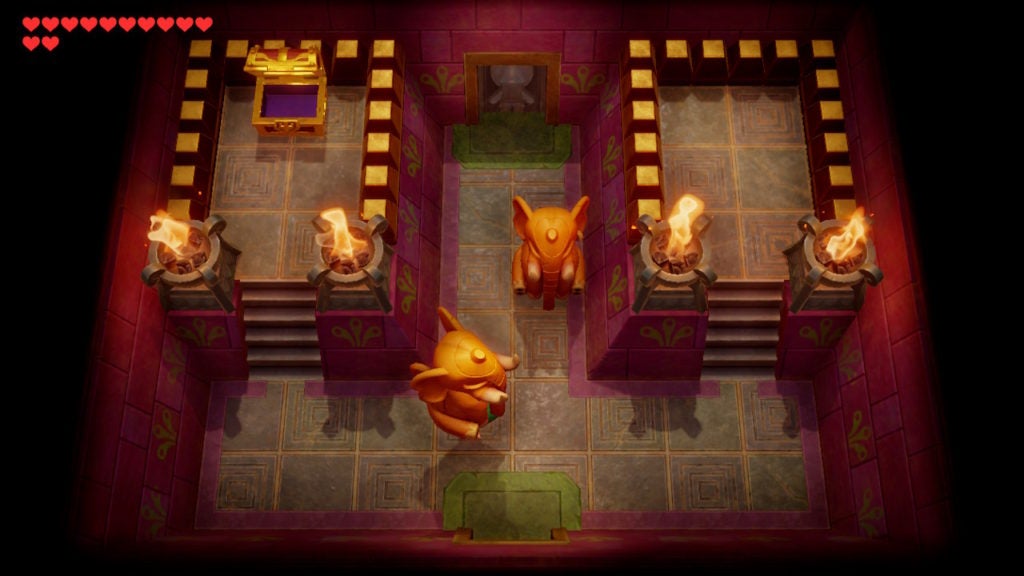 Link lifting up an elephant statue in the Powerful Bracelet chest room.