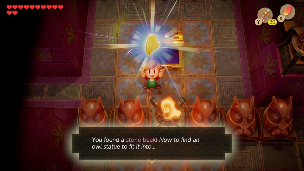 Link holding up the Stone Beak.