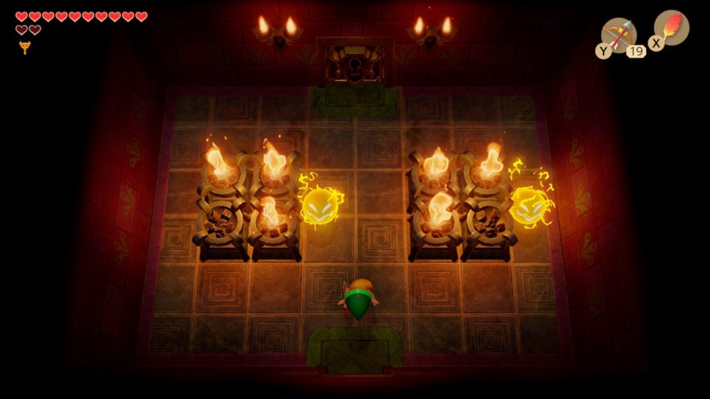 Link in a room with some partially lit torches and 2 Sparks.