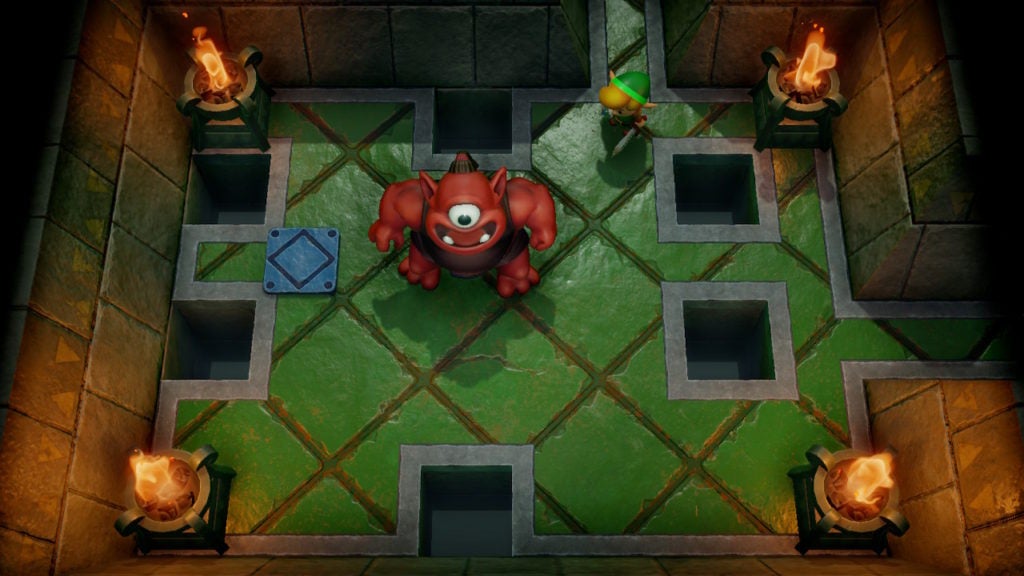 A muscular red cyclops in a room with a few floor holes.