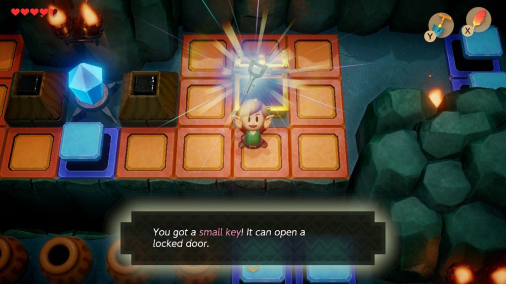Link happily holding up a small key after solving a switch puzzle.
