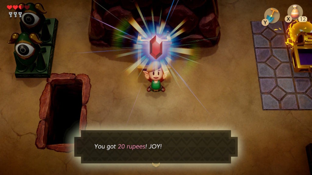 Link holding a red rupee worth 20 rupees above their head in Level 1 - Tail Cave's big central room.