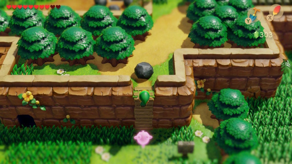 Link climbing a ladder with a rock at the top with the Pink Ghost behind him.