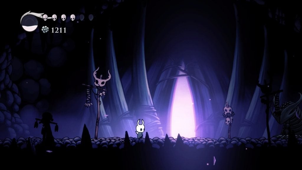 The Hollow Knight standing outside the Crystalised Mound.