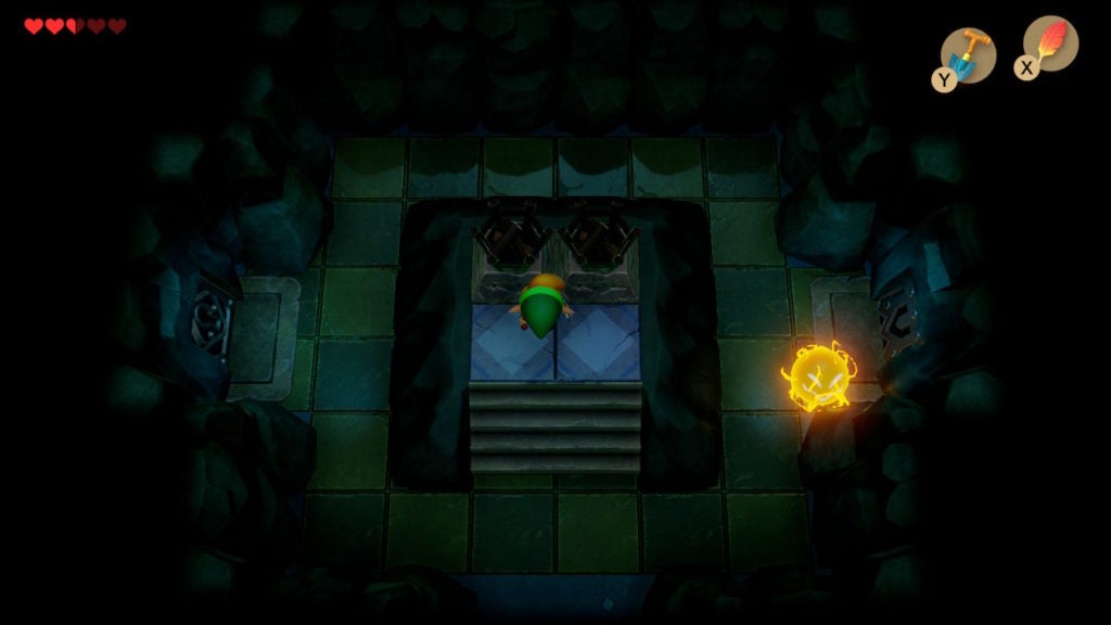 Room with 2 unlit torches in the center and 1 spark enemy patrolling around the room.