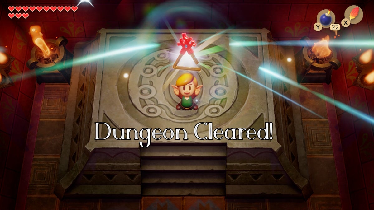 Link holding up the Coral Triangle with the text "dungeon cleared!" below him.