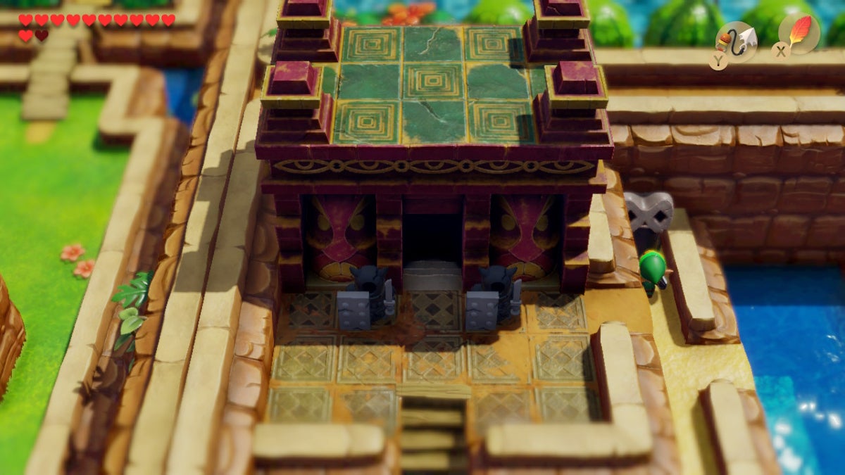 The maroon and teal stone entrance to Level 6 - Face Shrine.
