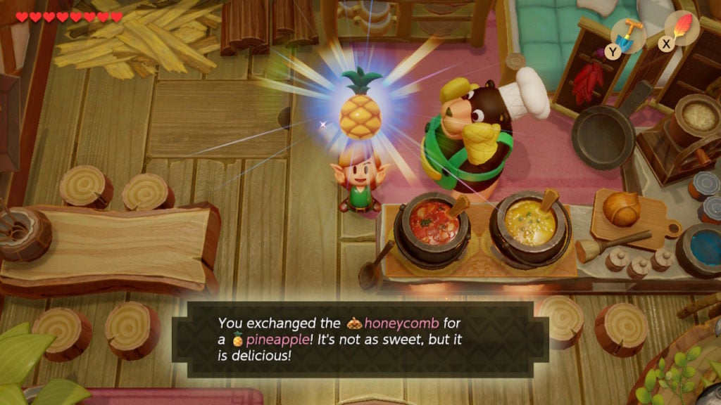 Link holding up the Pineapple trade quest item while standing next to chef bear, who is a literal bear.