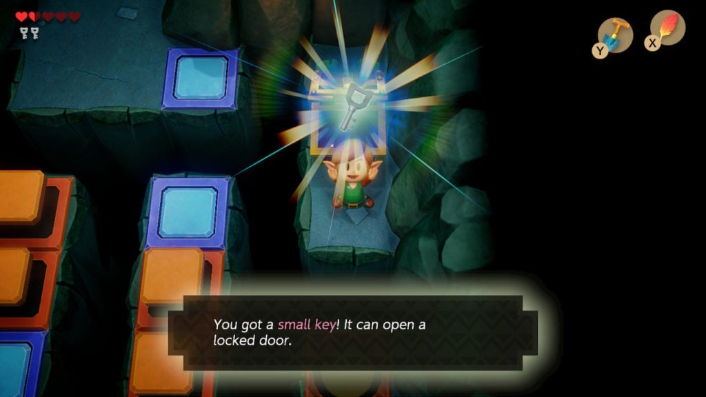 Link holding up a small key in joy.