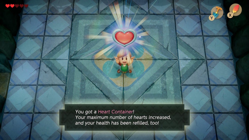 Link holding a heart container over their head happily after defeating Genie.