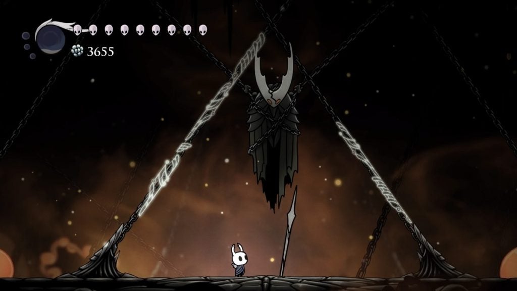 The Knight standing beneath a shackled Hollow Knight.
