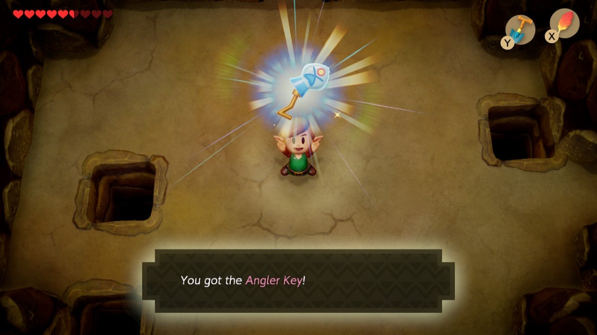 Link holding up the Angler Key, which is in the shape of a fish.