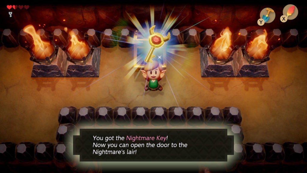 Link holding up the nightmare key above his head.