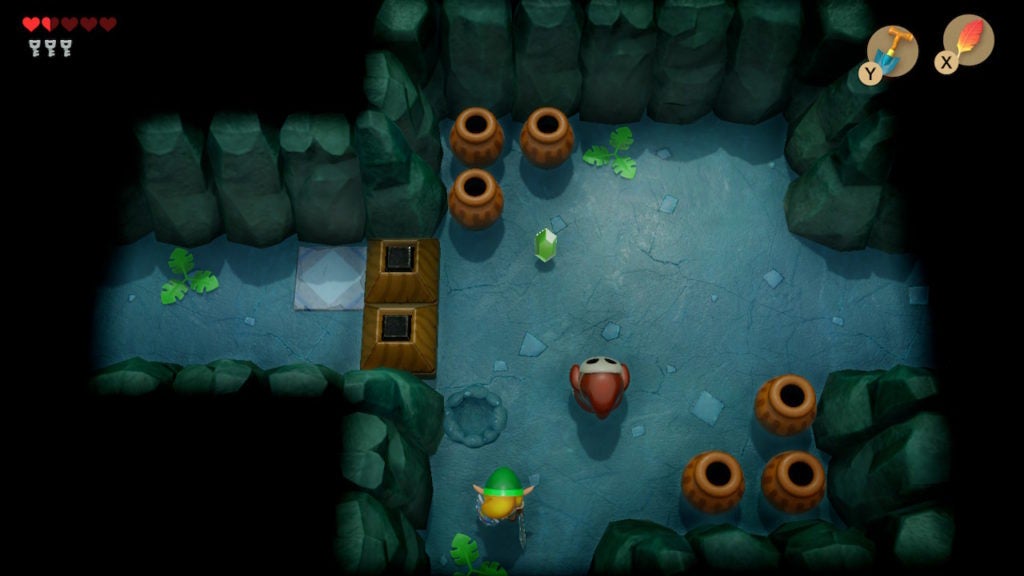 Link fighting shy guy in a room that has 2 blocks blocking the way to an ornate tile and a corridor leading west.