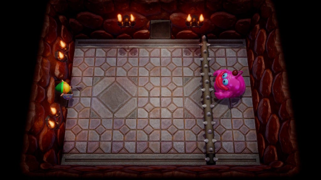The player comes face to face with Spike Roller, a large pink blob with arms that will roll a long spike-log at the player to hurt them.