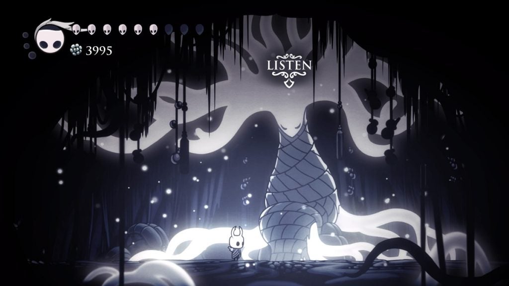 The Knight standing next to the White Lady in Hollow Knight.