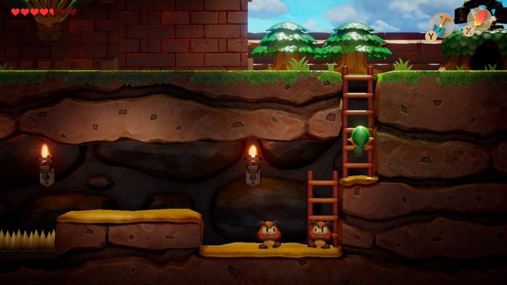 Link climbing down a ladder into an underground tunnel that has a couple of Goombas in it.