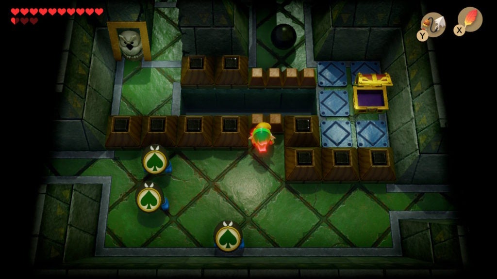Link throwing the round black stone across a gap to the north of a room with a chest.